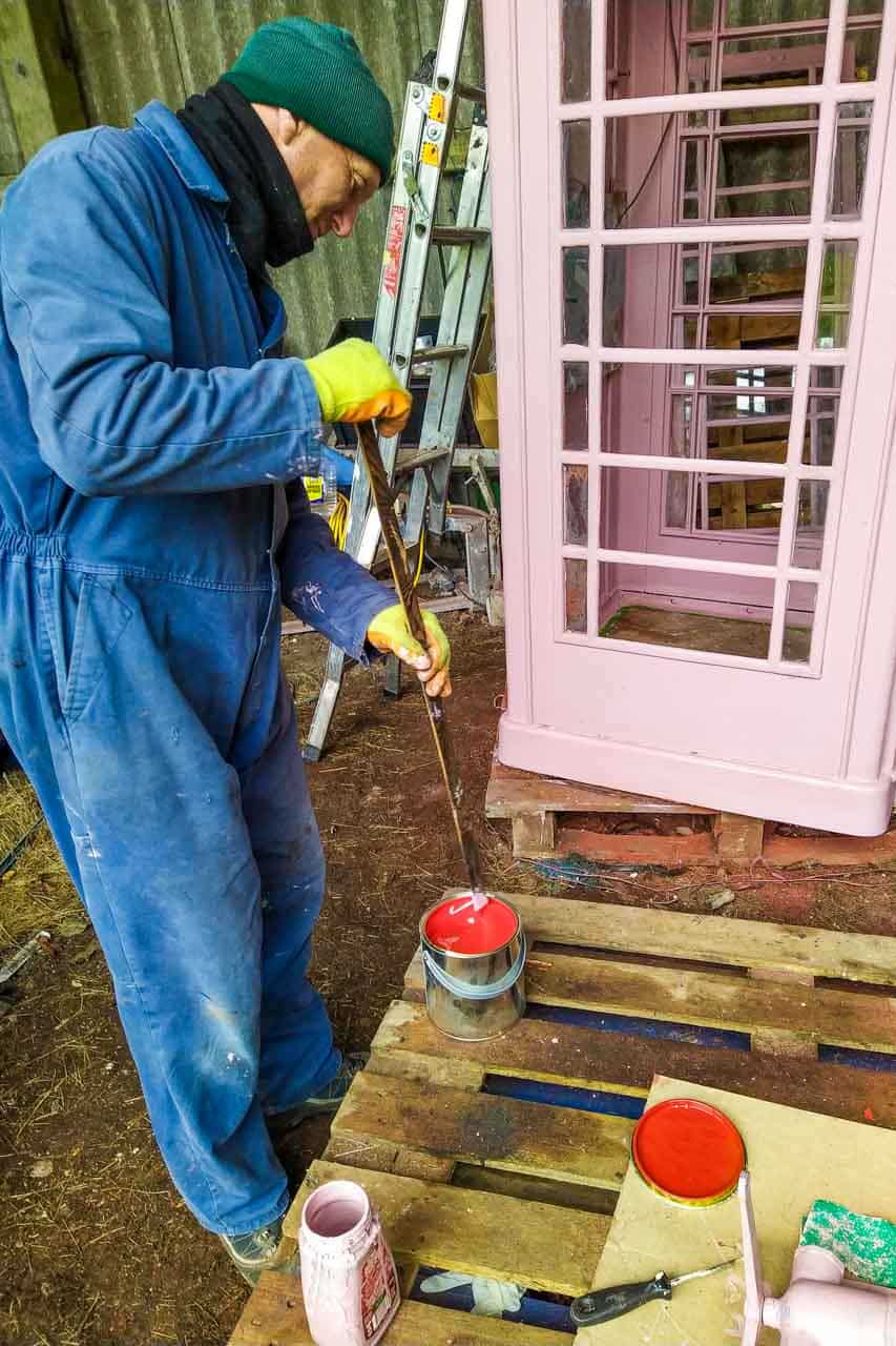 Ian stirs the Post Office red paint to cover the fetching pink undercoat.